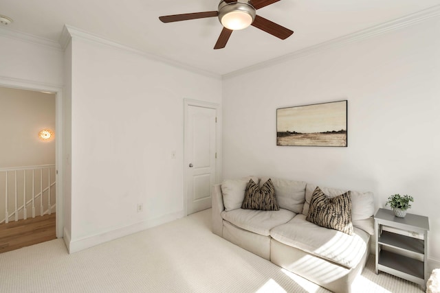 carpeted living room featuring ceiling fan and ornamental molding