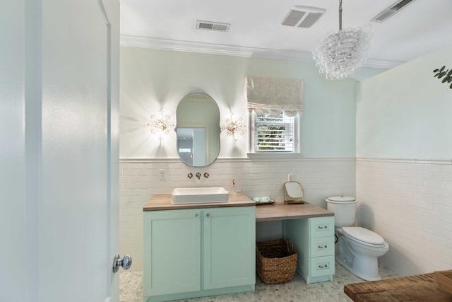 bathroom with ornamental molding, toilet, tile walls, and visible vents