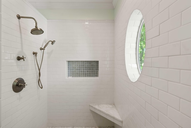 bathroom featuring crown molding and a tile shower