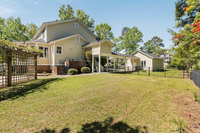 back of house with a lawn and a fenced backyard