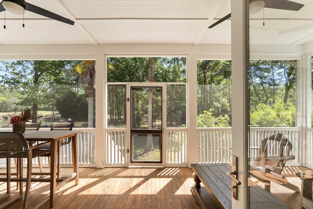 sunroom with outdoor dining area, a ceiling fan, and a healthy amount of sunlight