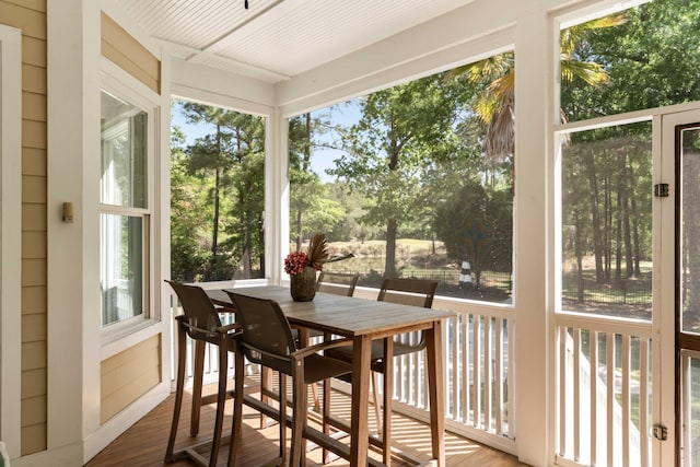 sunroom with a deck and wood finished floors