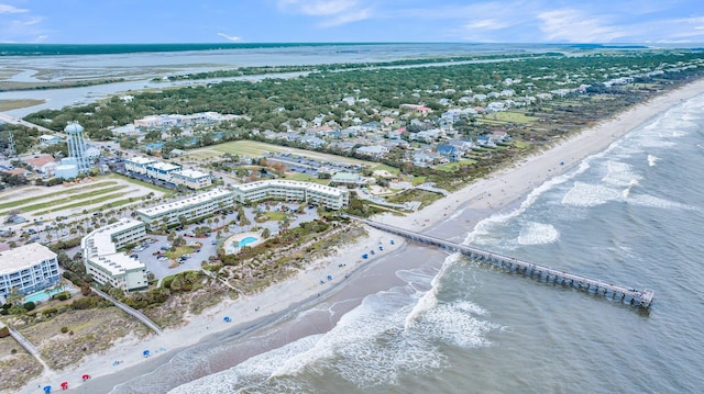 birds eye view of property featuring a beach view and a water view