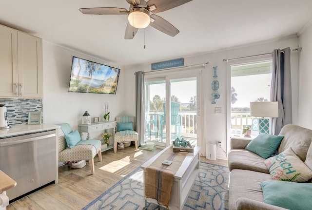 living room with ceiling fan and light wood-type flooring