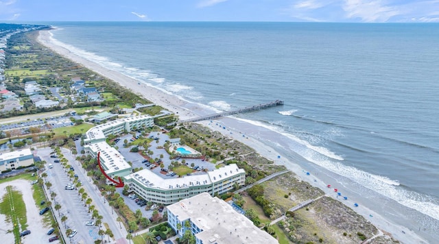 birds eye view of property featuring a water view and a beach view