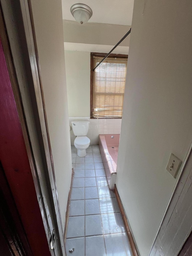 bathroom featuring tile patterned flooring and toilet