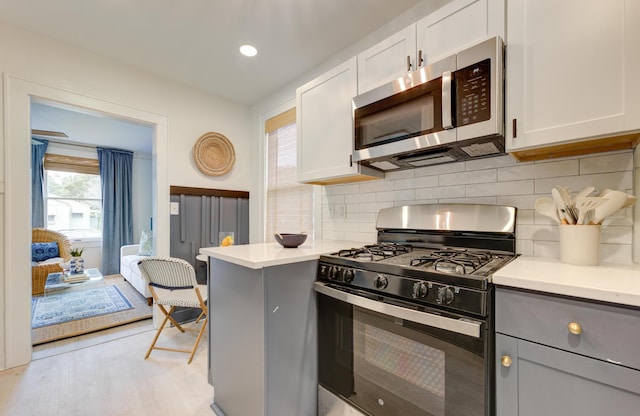 2317 Kent Ave, North Charleston, SC 29405 - kitchen with stainless steel microwave, gas stove, light countertops, tasteful backsplash, and recessed lighting