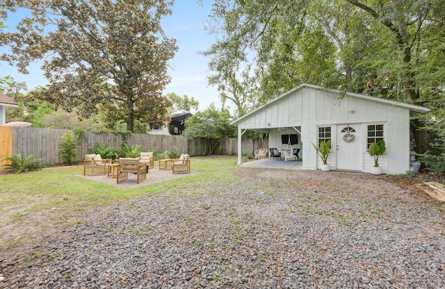 2317 Kent Ave, North Charleston, SC 29405 - fenced backyard with an outdoor fire pit and a patio area