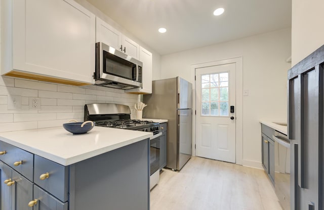 2317 Kent Ave, North Charleston, SC 29405 - kitchen featuring stainless steel appliances, tasteful backsplash, light wood-style flooring, white cabinets, and recessed lighting