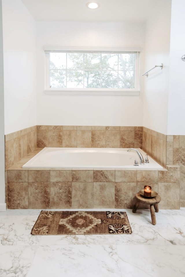 bathroom with tiled bath, recessed lighting, and a healthy amount of sunlight