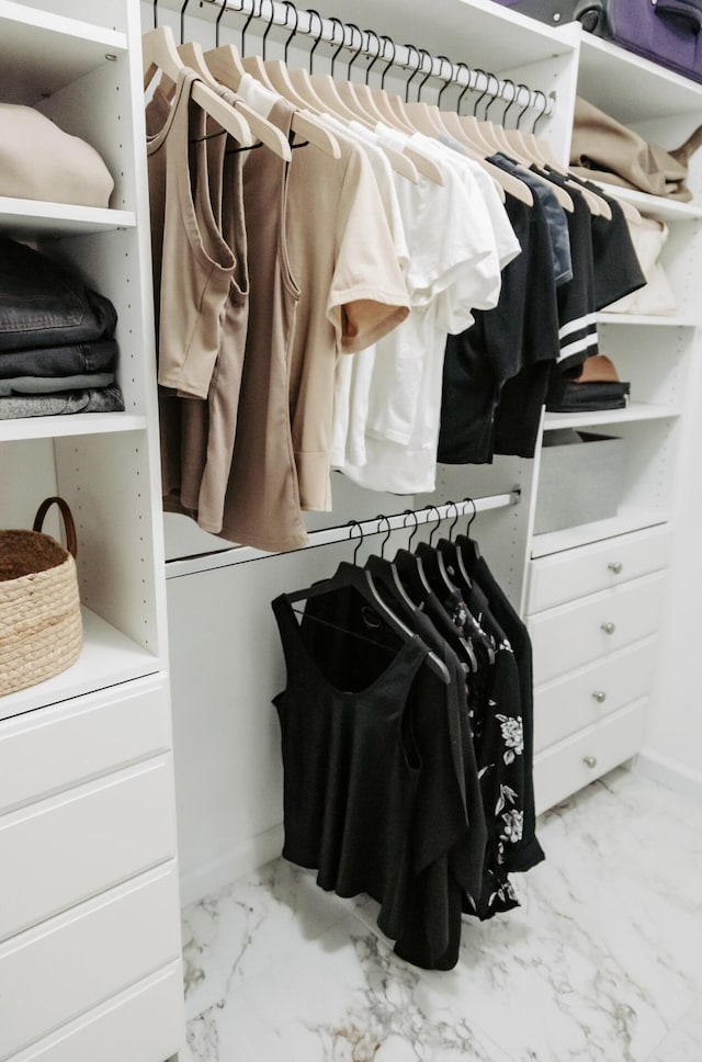 spacious closet featuring marble finish floor