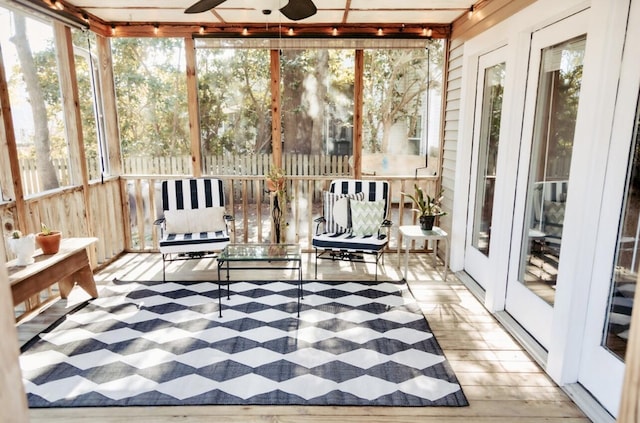 unfurnished sunroom featuring a ceiling fan