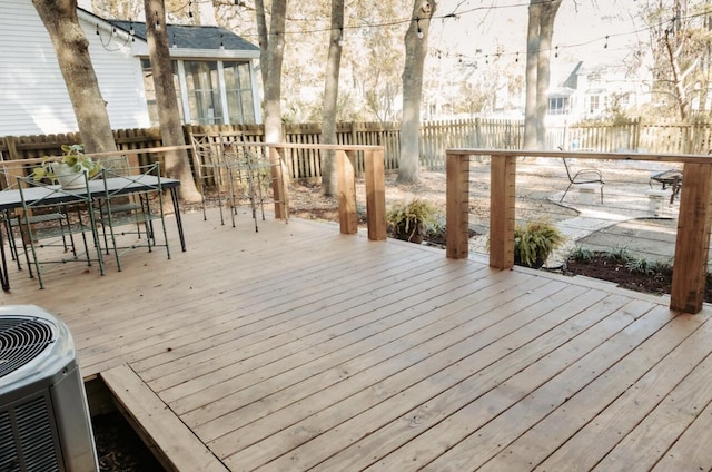 deck featuring fence, central AC, and outdoor dining space