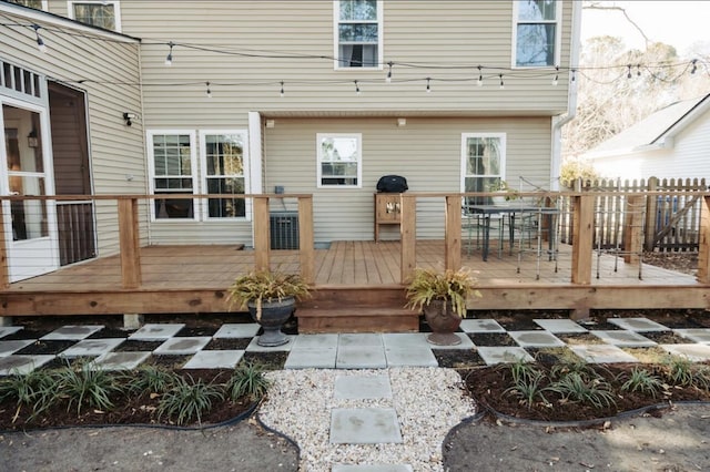 wooden terrace featuring fence