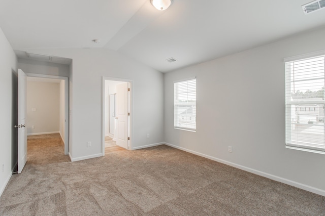 1816 Casein St, Summerville, SC 29483 - unfurnished bedroom featuring visible vents, baseboards, light colored carpet, connected bathroom, and vaulted ceiling