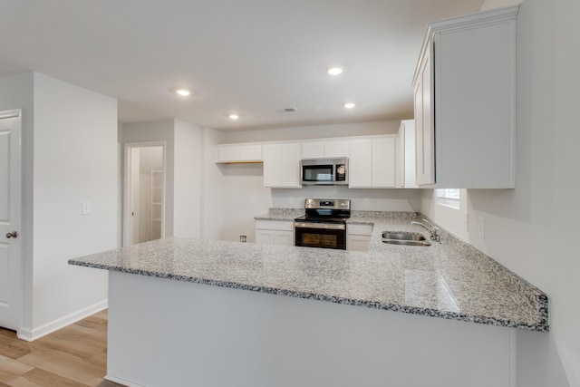1816 Casein St, Summerville, SC 29483 - kitchen with light wood-type flooring, a sink, appliances with stainless steel finishes, and light stone countertops