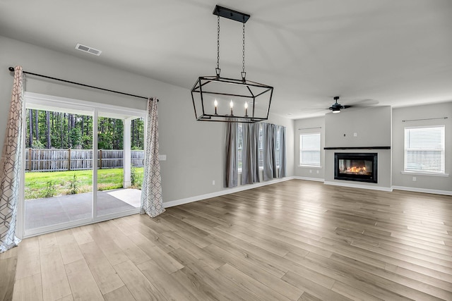4308 Cotton Flt Rd, Summerville, SC 29485 - unfurnished living room with a ceiling fan, wood finished floors, a glass covered fireplace, and baseboards