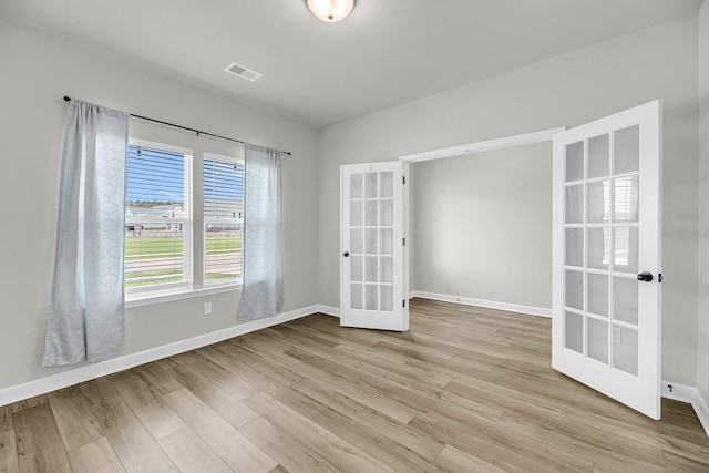 4308 Cotton Flt Rd, Summerville, SC 29485 - empty room featuring french doors, baseboards, and light wood-style flooring
