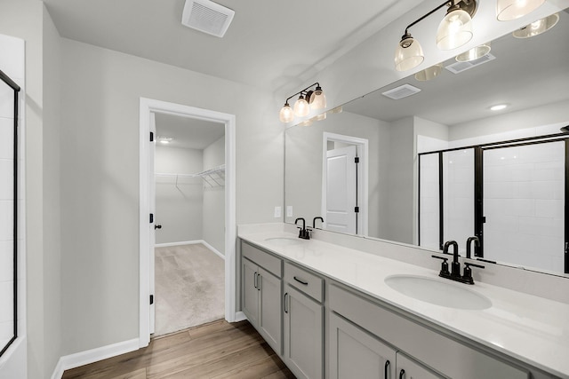 4308 Cotton Flt Rd, Summerville, SC 29485 - full bathroom with a spacious closet, a stall shower, double vanity, wood finished floors, and baseboards