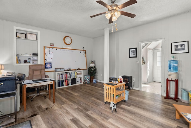 office space featuring wood-type flooring, a textured ceiling, and ceiling fan