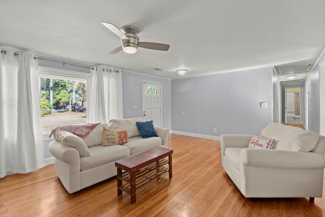 living room featuring light hardwood / wood-style floors and ceiling fan