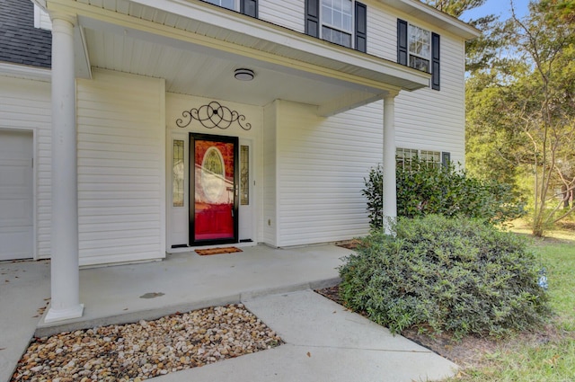 1600 Windsor Ln, Moncks Corner, SC 29461 - view of exterior entry with covered porch, roof with shingles, and an attached garage