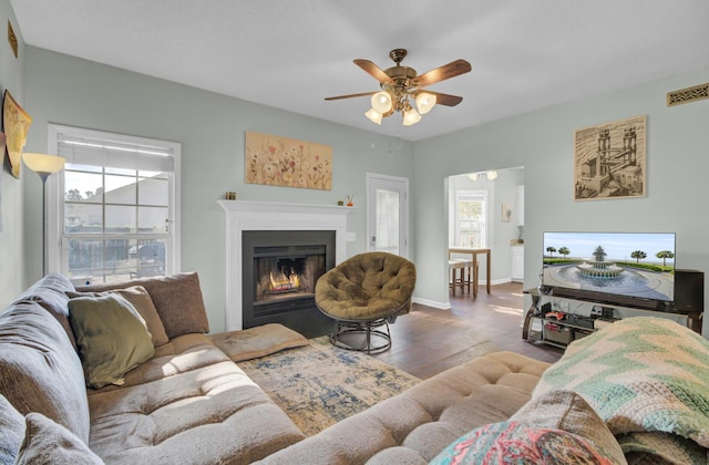 1600 Windsor Ln, Moncks Corner, SC 29461 - living room with plenty of natural light, a ceiling fan, wood finished floors, and a warm lit fireplace