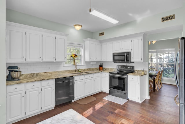 1600 Windsor Ln, Moncks Corner, SC 29461 - kitchen with appliances with stainless steel finishes, a sink, backsplash, light stone counters, and white cabinets