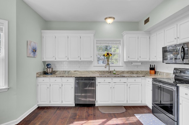 1600 Windsor Ln, Moncks Corner, SC 29461 - kitchen featuring stainless steel appliances, a sink, decorative backsplash, and light stone countertops