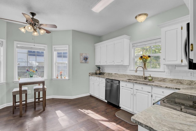 1600 Windsor Ln, Moncks Corner, SC 29461 - kitchen with stainless steel appliances, a sink, decorative backsplash, ceiling fan, and white cabinetry