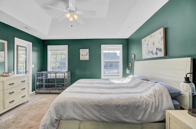 1600 Windsor Ln, Moncks Corner, SC 29461 - bedroom with carpet, a tray ceiling, and a ceiling fan