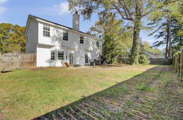 1600 Windsor Ln, Moncks Corner, SC 29461 - rear view of house with a chimney, an outdoor fire pit, and a patio
