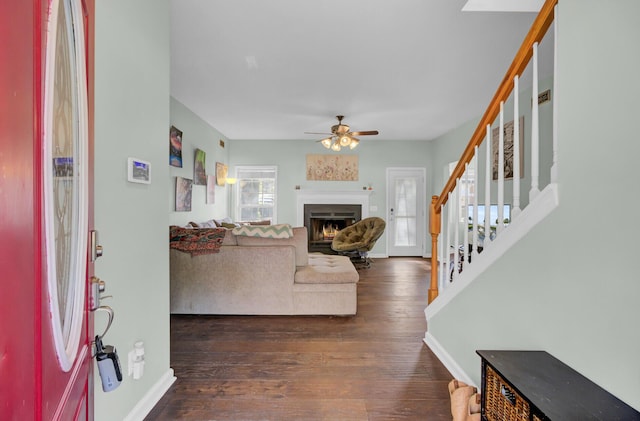 1600 Windsor Ln, Moncks Corner, SC 29461 - entryway with a warm lit fireplace, dark wood-style flooring, ceiling fan, and baseboards