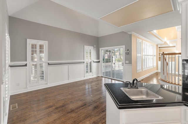 kitchen featuring white cabinetry, dark wood-type flooring, and sink