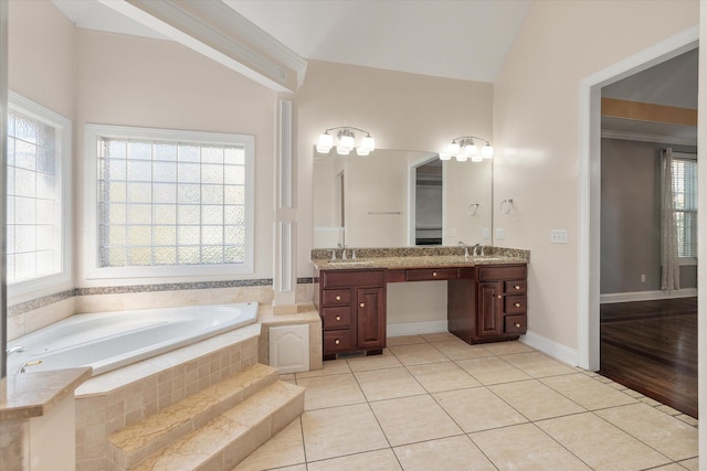 bathroom featuring tile patterned flooring, vanity, a relaxing tiled tub, and vaulted ceiling