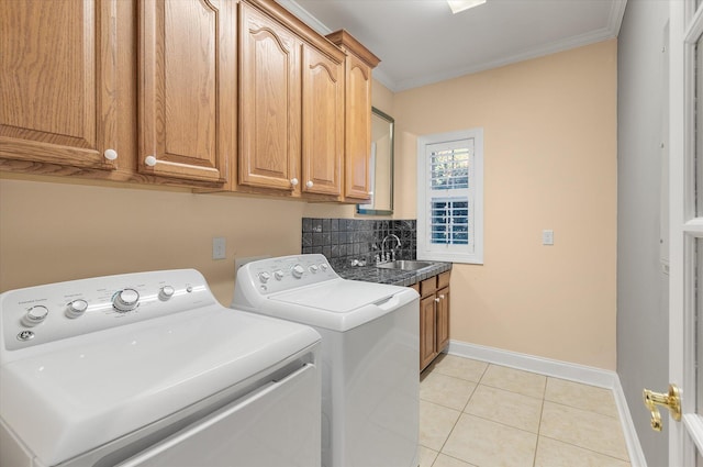 laundry area with separate washer and dryer, sink, cabinets, ornamental molding, and light tile patterned floors