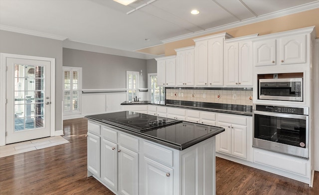 kitchen with a healthy amount of sunlight, white cabinets, and appliances with stainless steel finishes