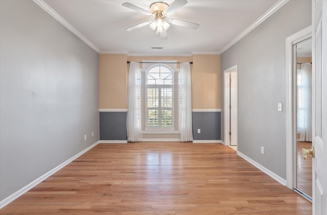 spare room featuring ornamental molding, ceiling fan, and light wood-type flooring