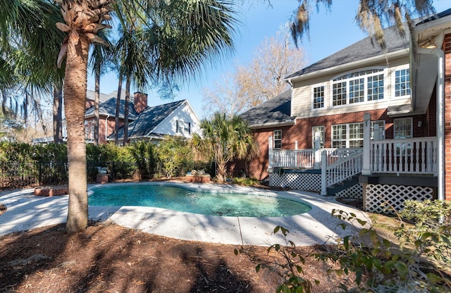 view of swimming pool with a deck