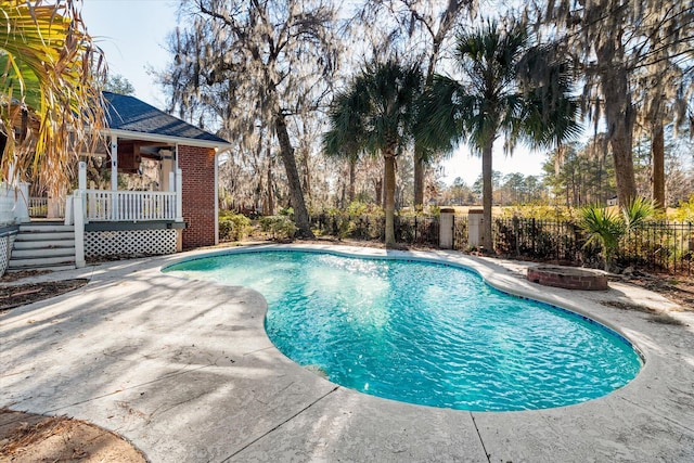 view of swimming pool featuring a patio and an outdoor fire pit