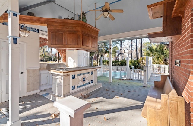 deck featuring area for grilling and ceiling fan