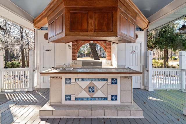 deck with sink, grilling area, and exterior kitchen