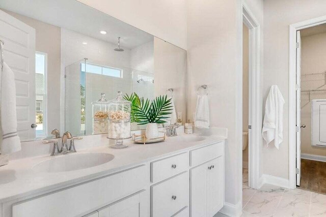 bathroom featuring vanity and a shower with shower door