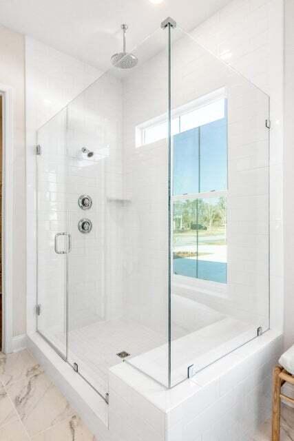 bathroom featuring a shower with door