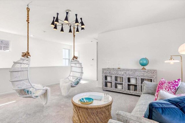 living room featuring carpet floors and an inviting chandelier