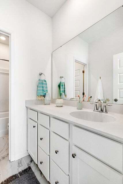 bathroom with vanity and washtub / shower combination