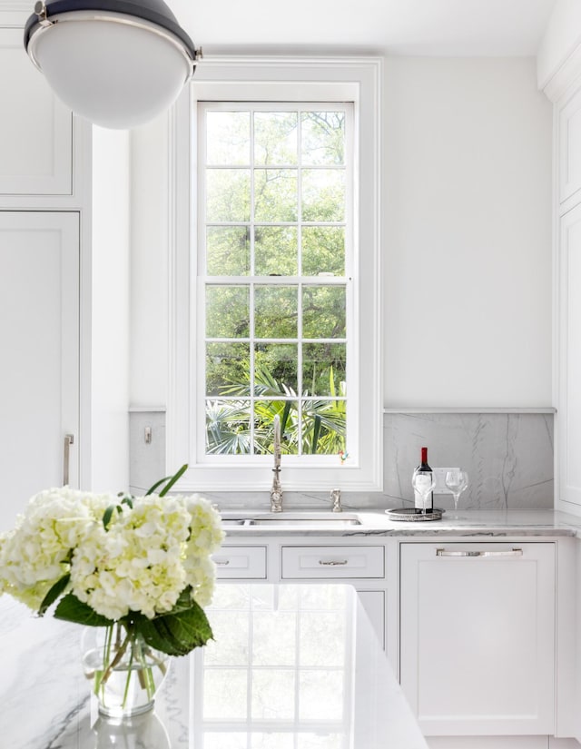 interior space with decorative backsplash and white cabinetry