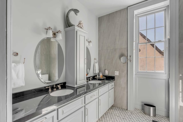 bathroom with tile patterned flooring, vanity, and a wealth of natural light