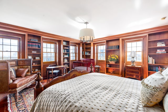 bedroom featuring multiple windows, crown molding, and hardwood / wood-style floors