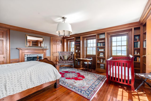 bedroom featuring hardwood / wood-style flooring and ornamental molding